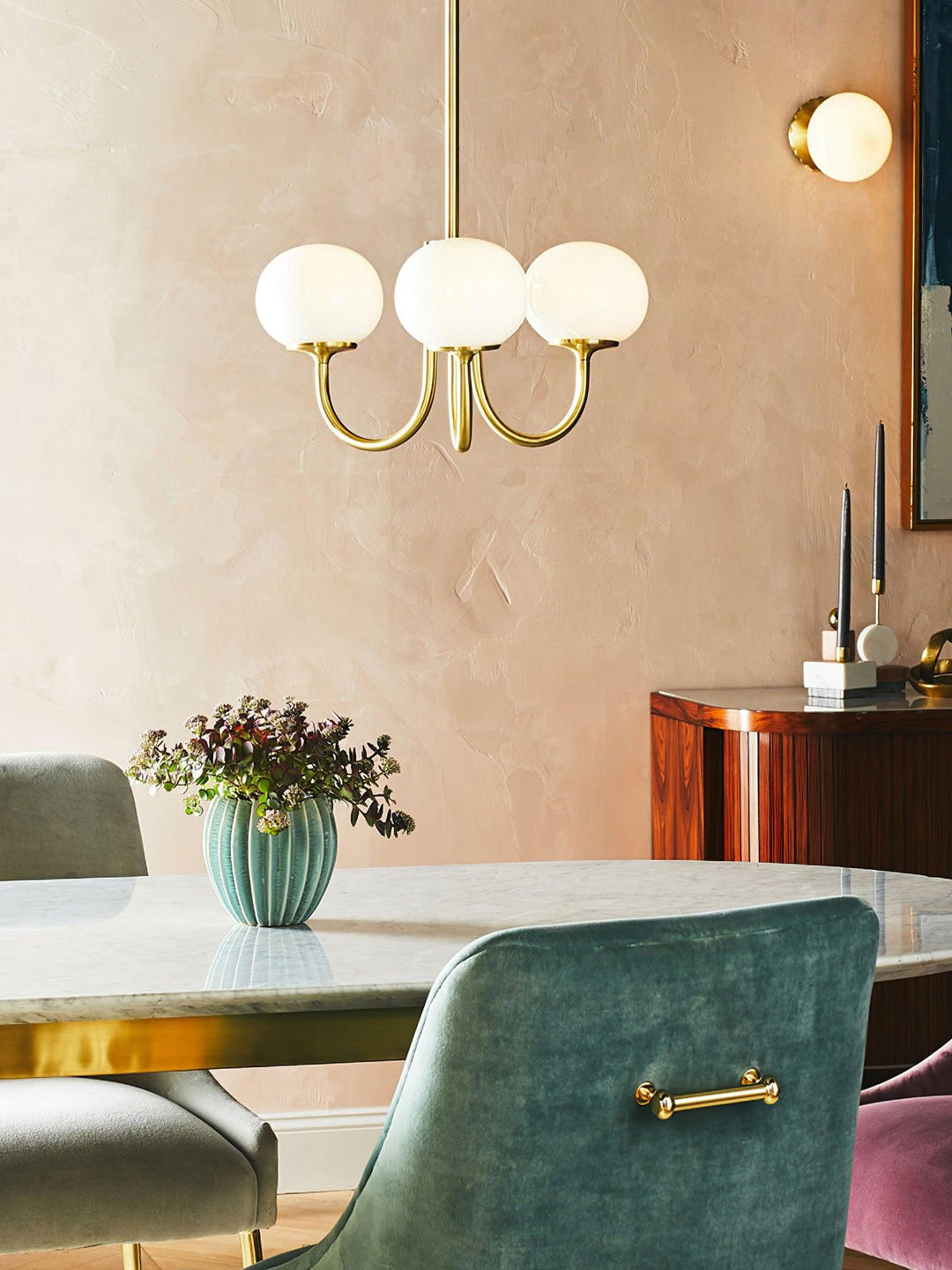 Modern pink and gold chandelier with elegant glass shades, ideal ceiling light fixture for chic home decor and illumination.