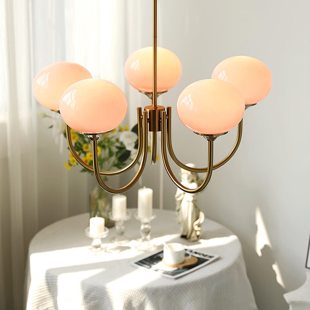 Modern pink and gold chandelier with elegant glass shades, ideal ceiling light fixture for chic home decor and illumination.