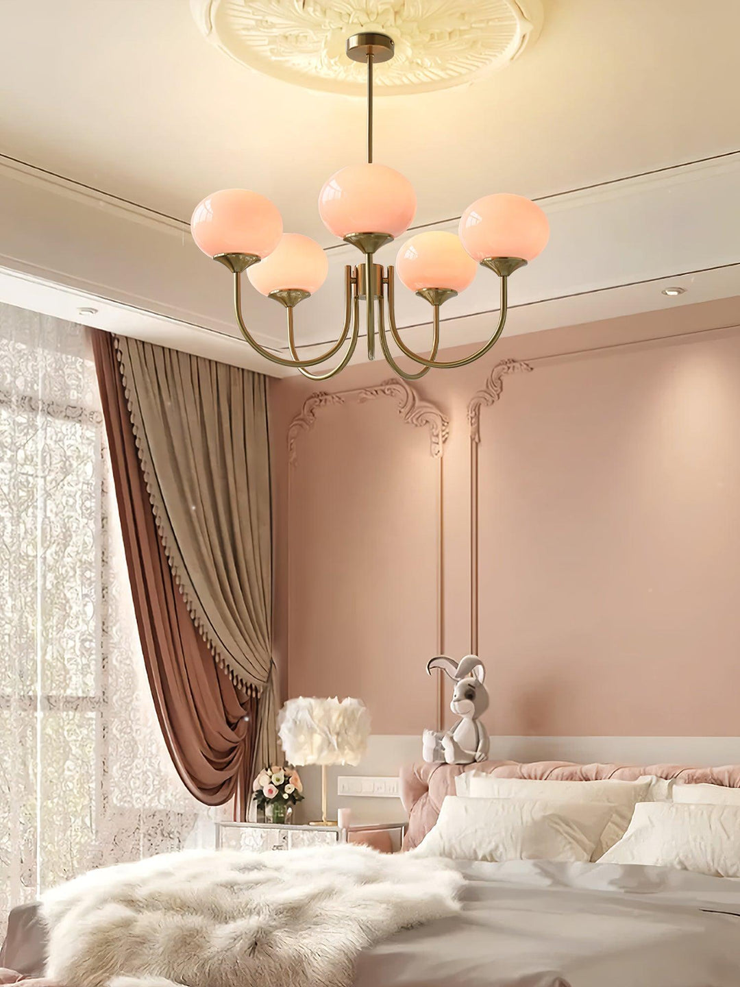 Modern pink and gold chandelier with elegant glass shades, ideal ceiling light fixture for chic home decor and illumination.
