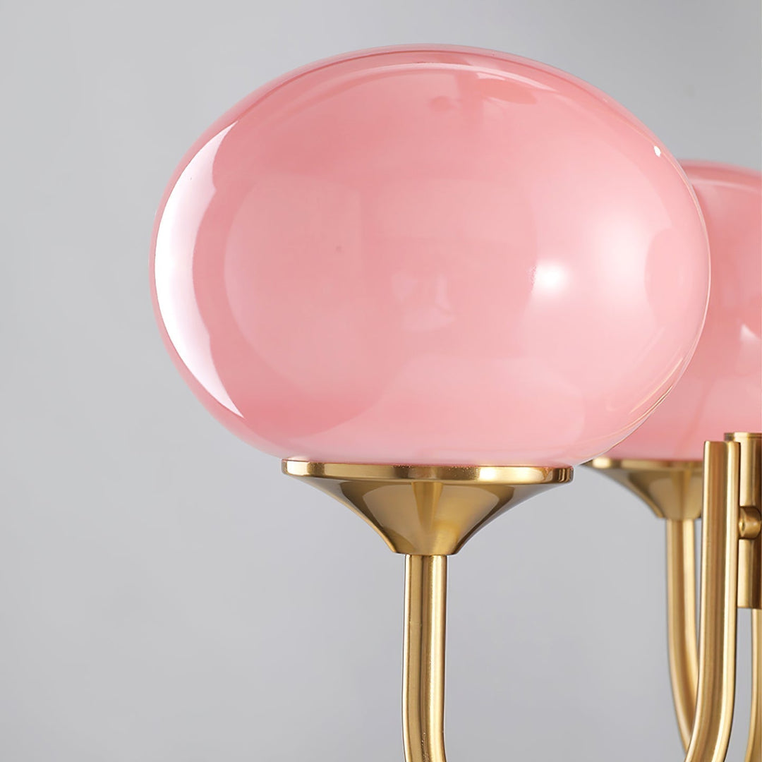 Modern pink and gold chandelier with elegant glass shades, ideal ceiling light fixture for chic home decor and illumination.