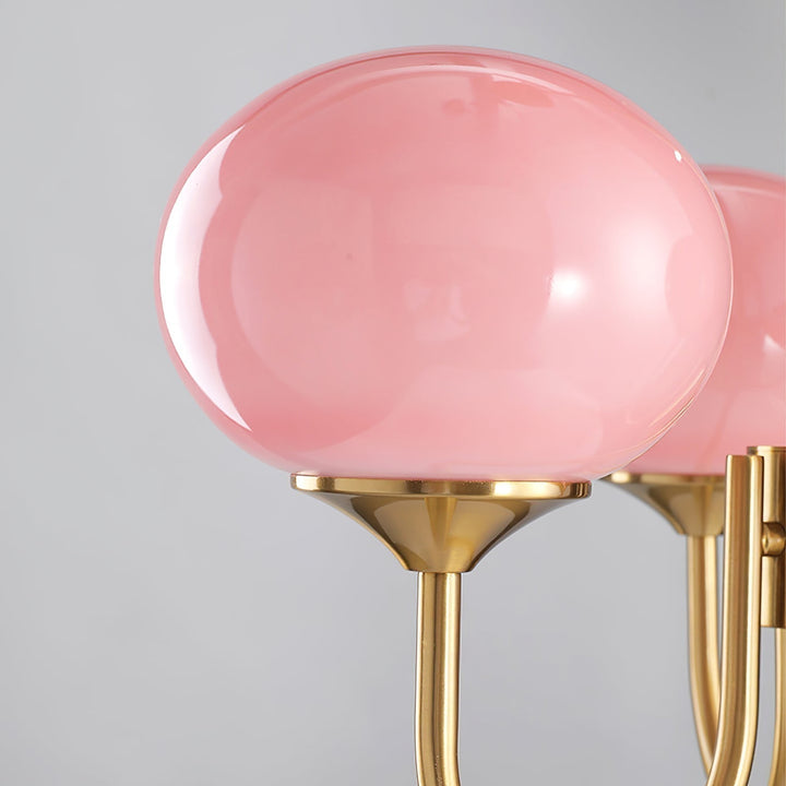 Modern pink and gold chandelier with elegant glass shades, ideal ceiling light fixture for chic home decor and illumination.