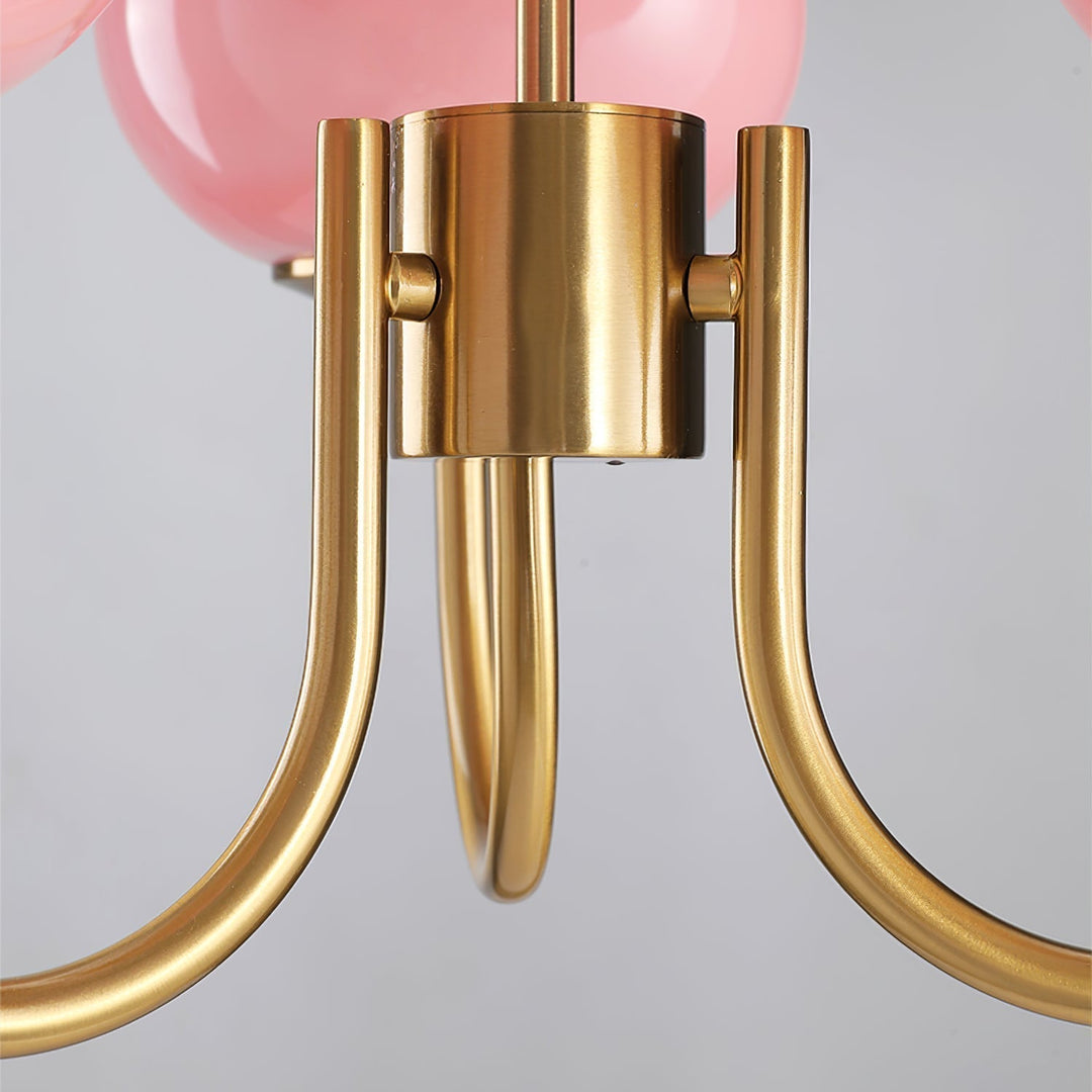 Modern pink and gold chandelier with elegant glass shades, ideal ceiling light fixture for chic home decor and illumination.