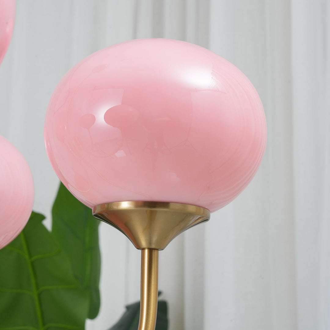 Modern pink and gold chandelier with elegant glass shades, ideal ceiling light fixture for chic home decor and illumination.