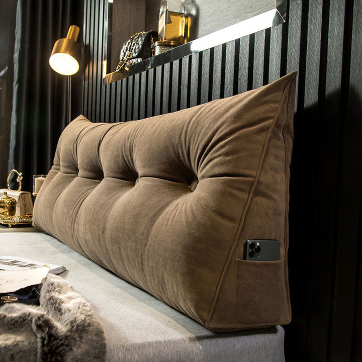 "Multi-coloured ergonomic wedge pillow for back support; shown in brown, yellow, and orange with a handy side pocket."