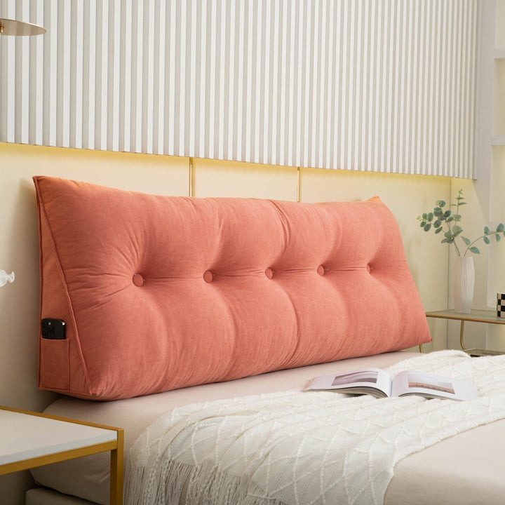 "Multi-coloured ergonomic wedge pillow for back support; shown in brown, yellow, and orange with a handy side pocket."