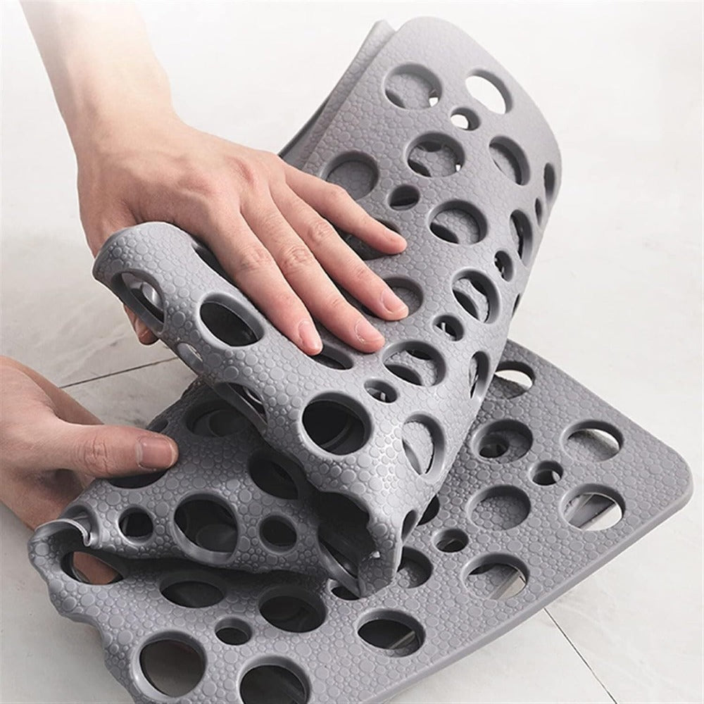 Non-slip shower mat with suction cups, textured for comfort, mold-resistant, in blue, green, grey; enhances bathroom safety.
