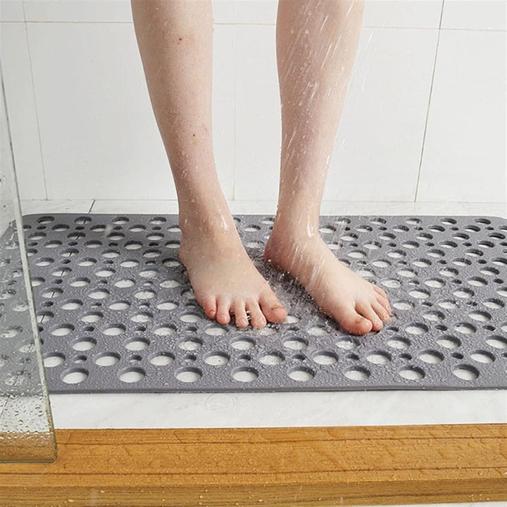 Non-slip shower mat with suction cups, textured for comfort, mold-resistant, in blue, green, grey; enhances bathroom safety.