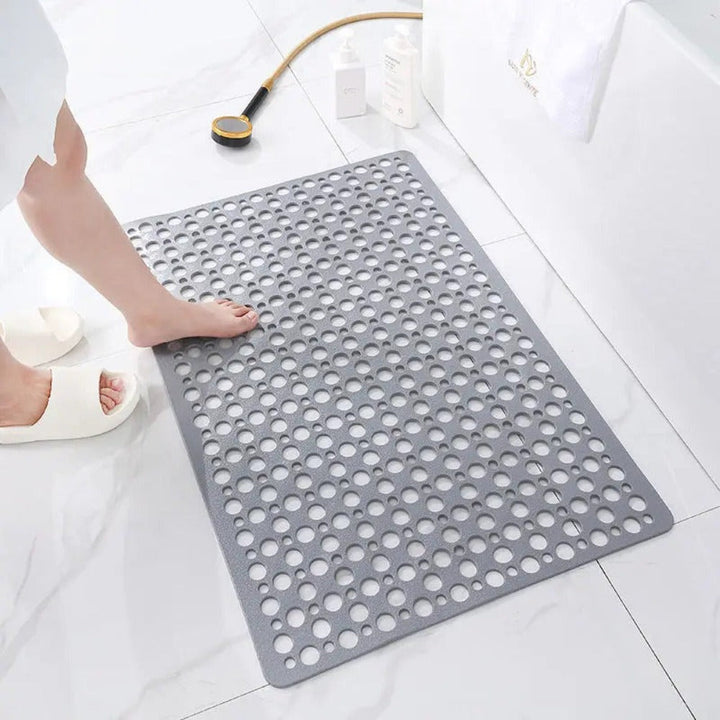 Non-slip shower mat with suction cups, textured for comfort, mold-resistant, in blue, green, grey; enhances bathroom safety.