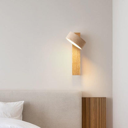 "Off-white travertine wall lamp with LED light, minimalist design, wood accents, ideal for ambient bedroom lighting."