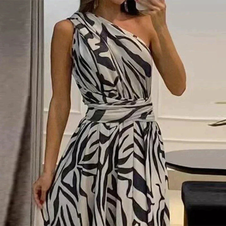 One-shoulder zebra print chiffon maxi dress with high slit, elegant and airy, perfect for summer events.