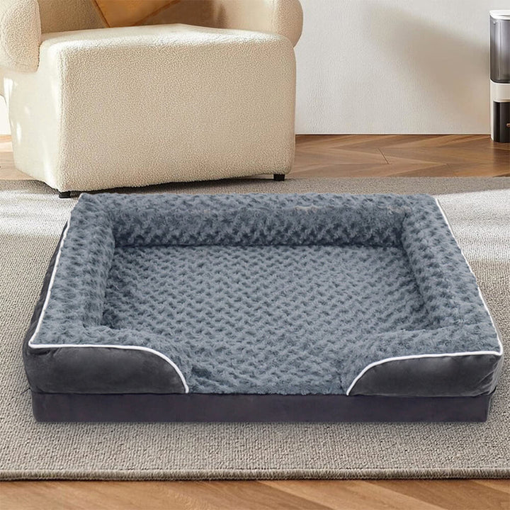 Orthopedic waterproof dog bed with thick foam base, raised edges, and plush cover for ultimate joint support and comfort.