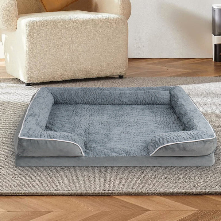 Orthopedic waterproof dog bed with thick foam base, raised edges, and plush cover for ultimate joint support and comfort.