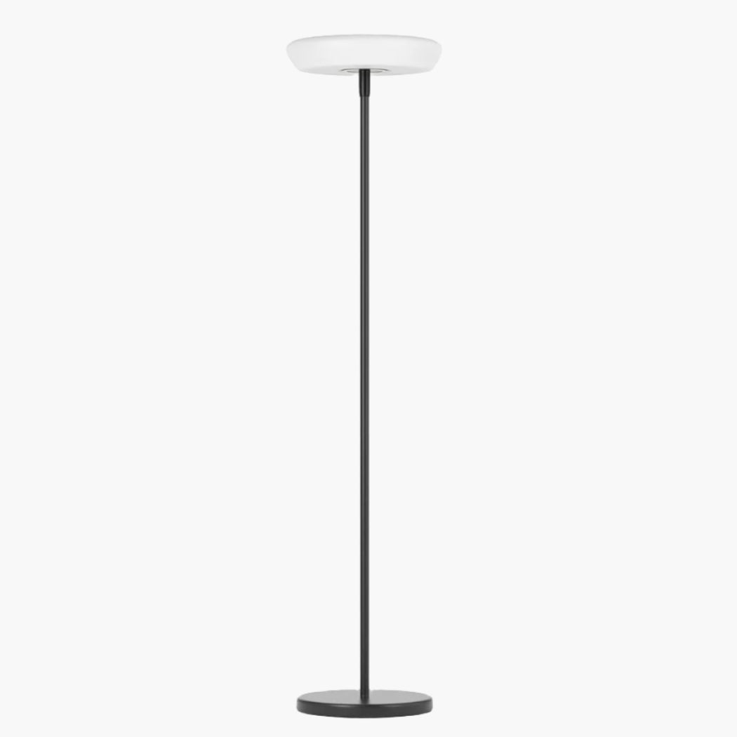 Outdoor solar floor lamp with metal and acrylic body, modern design, stands on patio illuminating with warm LED glow.