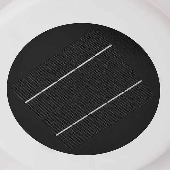 Outdoor solar floor lamp with metal and acrylic body, modern design, stands on patio illuminating with warm LED glow.