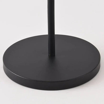 Outdoor solar floor lamp with metal and acrylic body, modern design, stands on patio illuminating with warm LED glow.