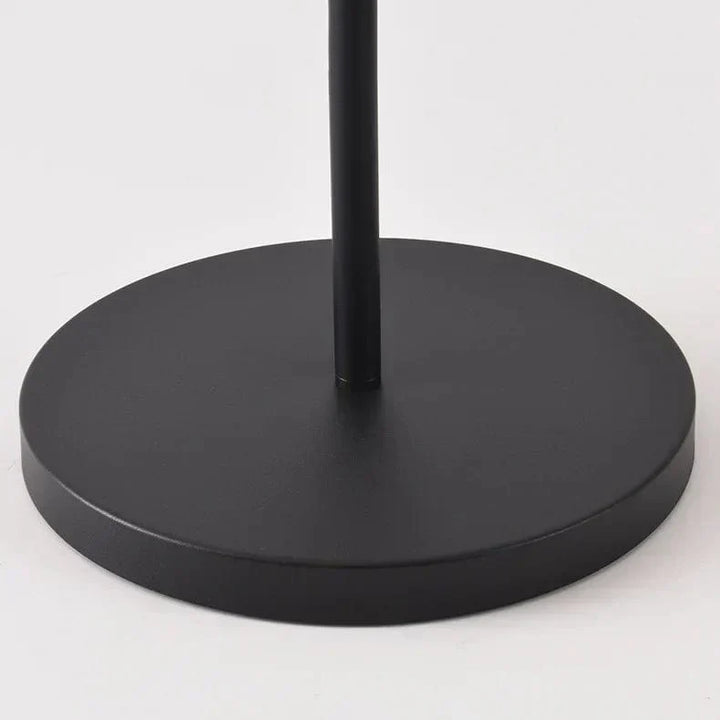Outdoor solar floor lamp with metal and acrylic body, modern design, stands on patio illuminating with warm LED glow.