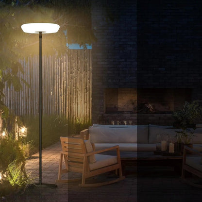 Outdoor solar floor lamp with metal and acrylic body, modern design, stands on patio illuminating with warm LED glow.