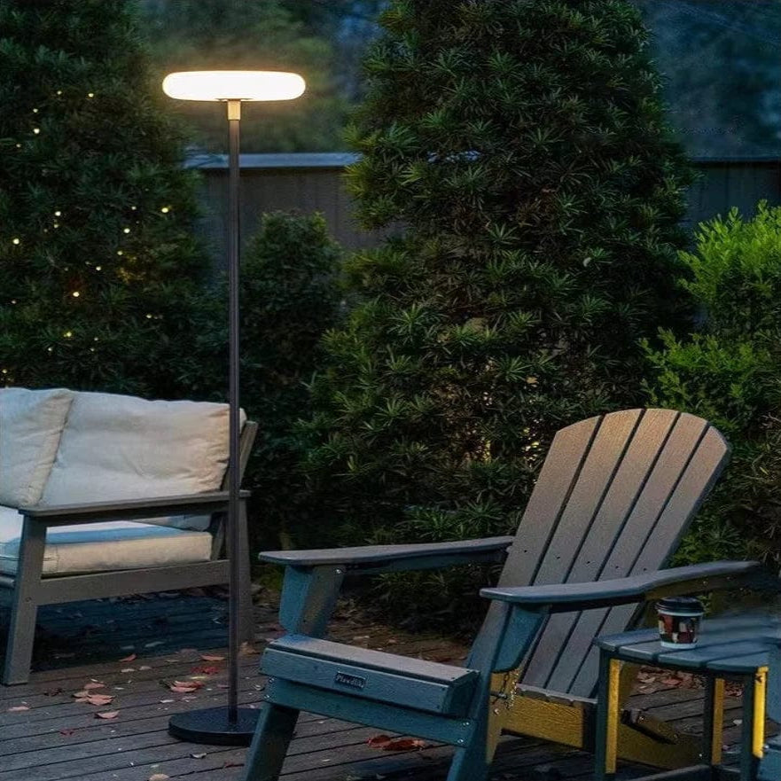 Outdoor solar floor lamp with metal and acrylic body, modern design, stands on patio illuminating with warm LED glow.
