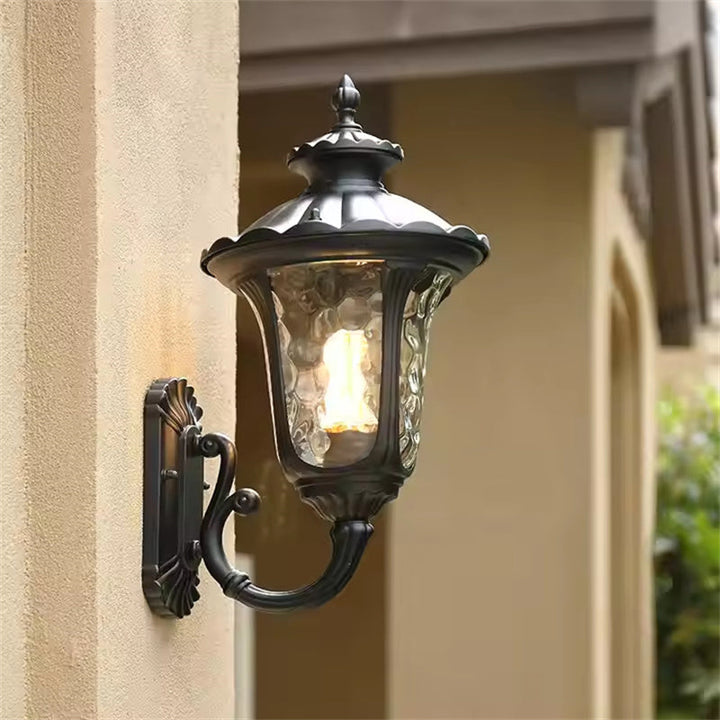 "Outdoor waterproof bronze wall light with clear water glass shade, elegant design for stylish exterior lighting."