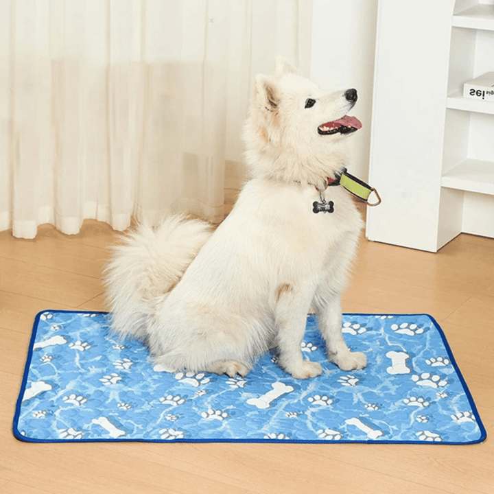 "Pale blue pet cooling mat on beige sofa provides comfort for dogs and cats during summer, featuring self-cooling ice silk fa