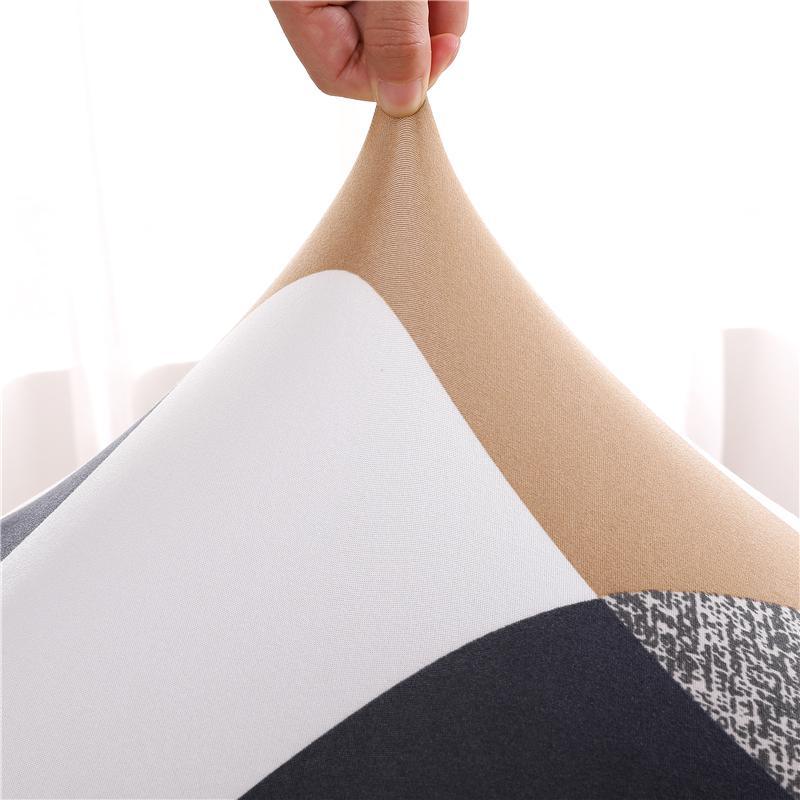 Patterned prismatic chair cover enhancing elegance; high-elasticity, anti-slip, durable fabric for stylish home décor.