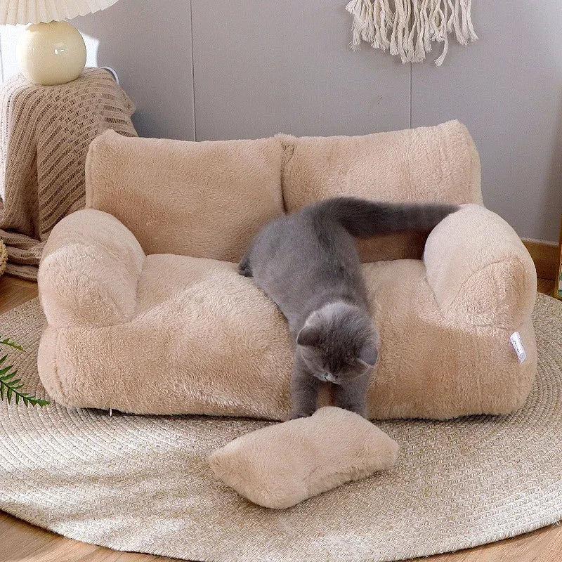 Plush cat sofa bed in pink, featuring soft material and raised edges for feline comfort and style, perfect for pet relaxation