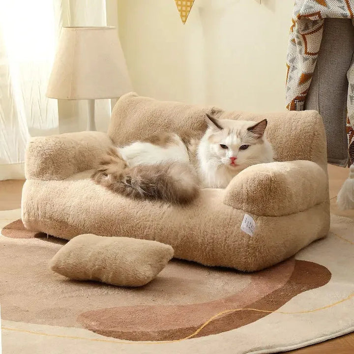Plush cat sofa bed in pink, featuring soft material and raised edges for feline comfort and style, perfect for pet relaxation