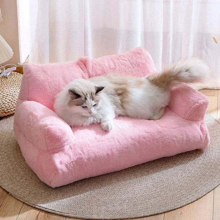 Plush cat sofa bed in pink, featuring soft material and raised edges for feline comfort and style, perfect for pet relaxation