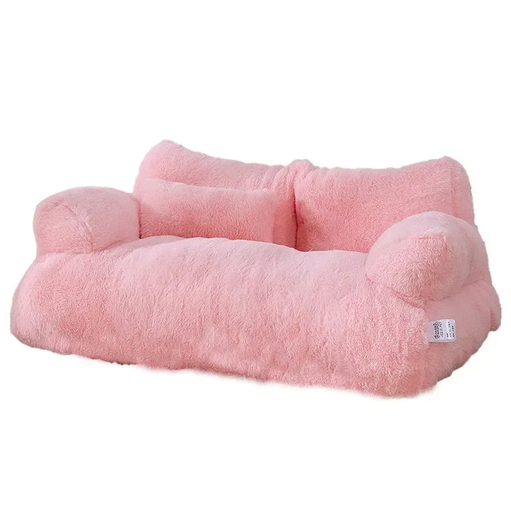 Plush cat sofa bed in pink, featuring soft material and raised edges for feline comfort and style, perfect for pet relaxation