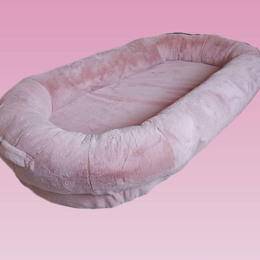 "Plush oversized lounger for pets and owners, featuring gray memory foam and plush bolsters for ultimate comfort and style."