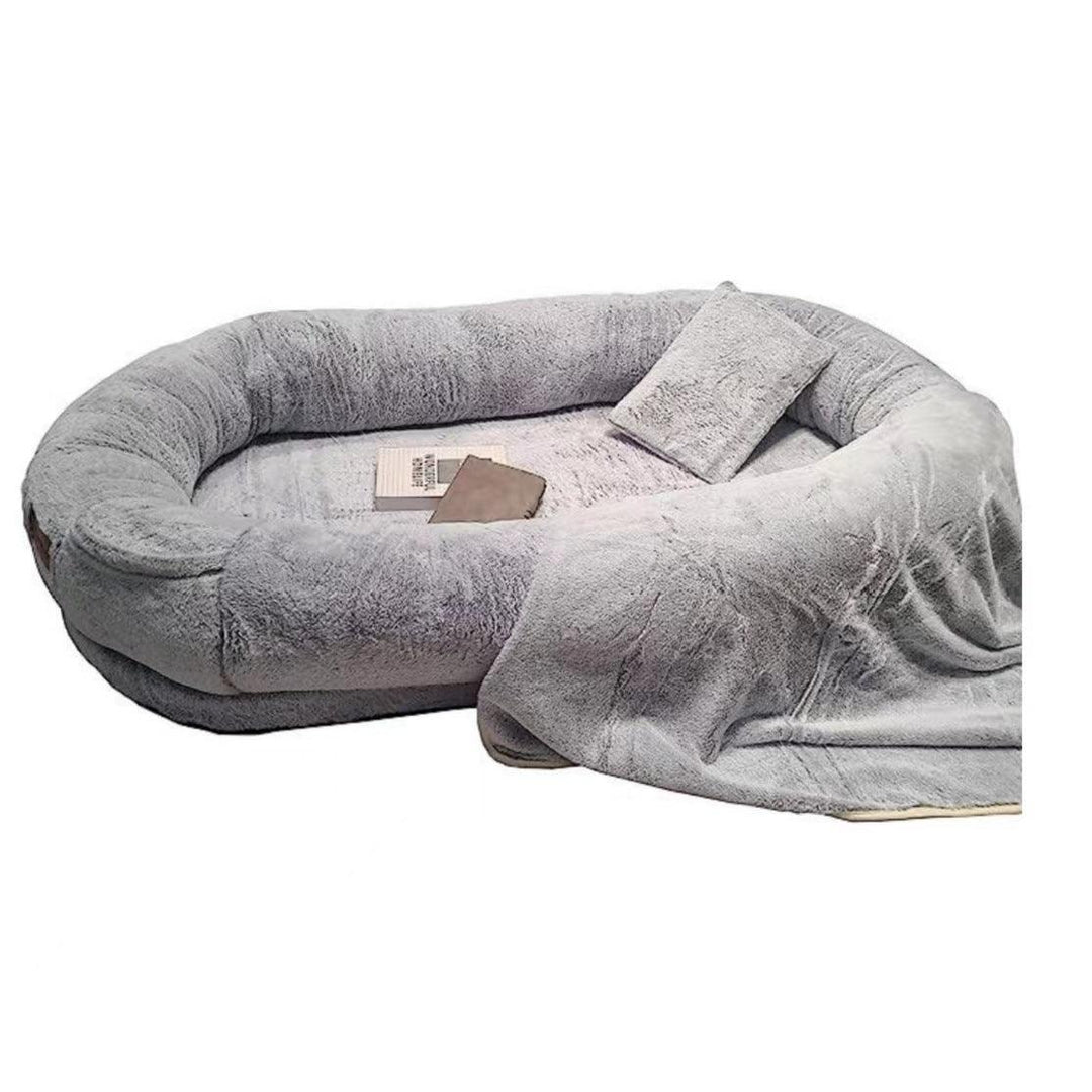 "Plush oversized lounger for pets and owners, featuring gray memory foam and plush bolsters for ultimate comfort and style."