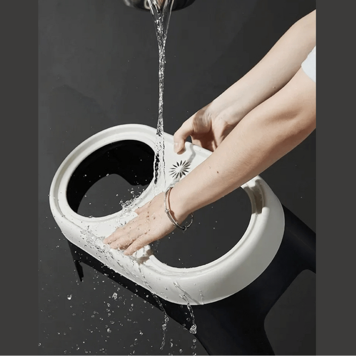 "Raised dog feeding station with sleek stainless steel bowls on a stable, non-slip base for mess-free, stylish dining."