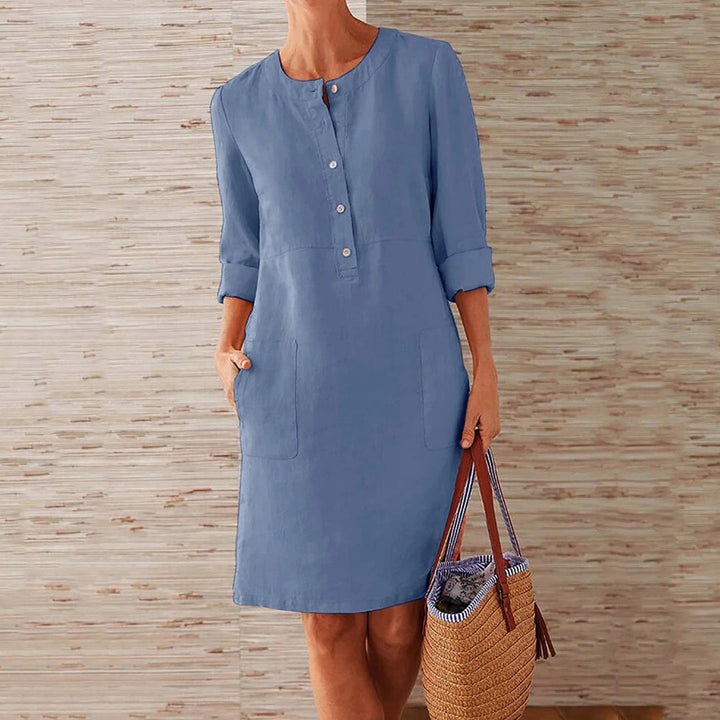 Sky blue women's casual midi dress with long sleeves and side pockets, featuring a round neckline, perfect for everyday wear.