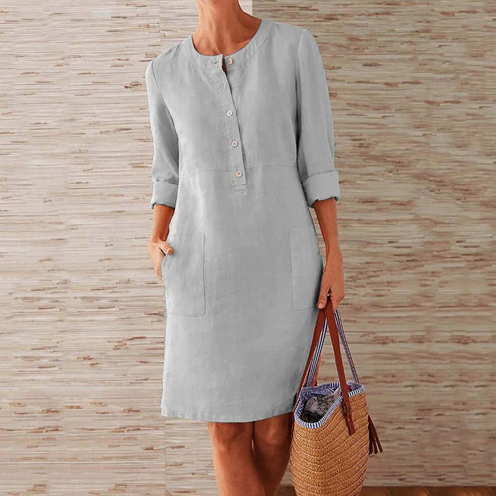 Sky blue women's casual midi dress with long sleeves and side pockets, featuring a round neckline, perfect for everyday wear.