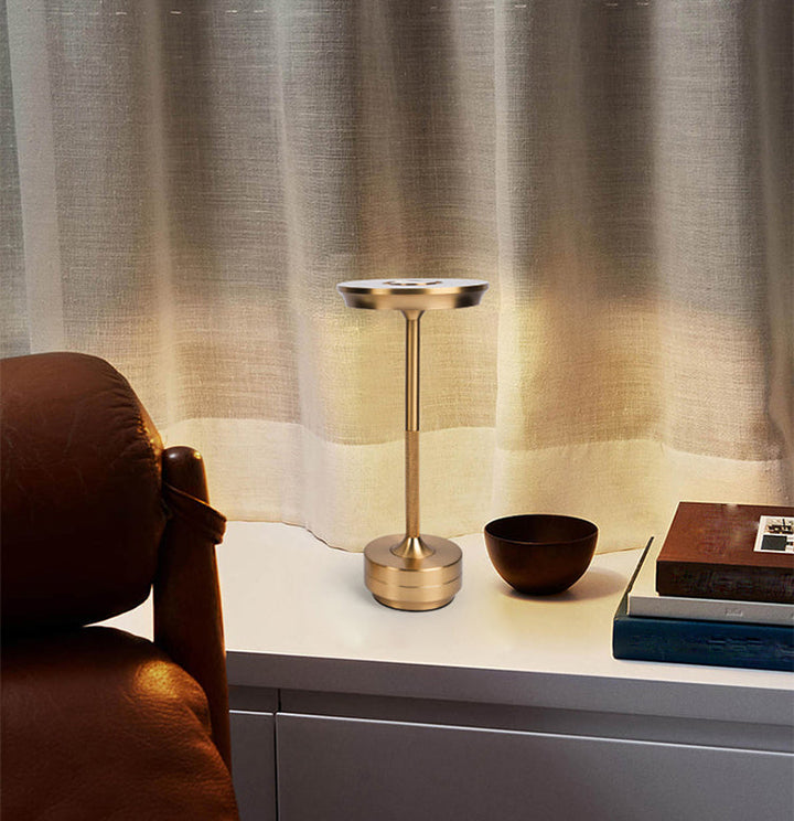"Sleek cordless LED table lamp with a touch sensor, featuring a minimalist design in available colors: black, gold, silver."