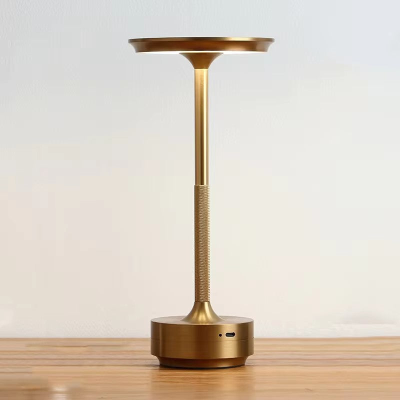 "Sleek cordless LED table lamp with a touch sensor, featuring a minimalist design in available colors: black, gold, silver."