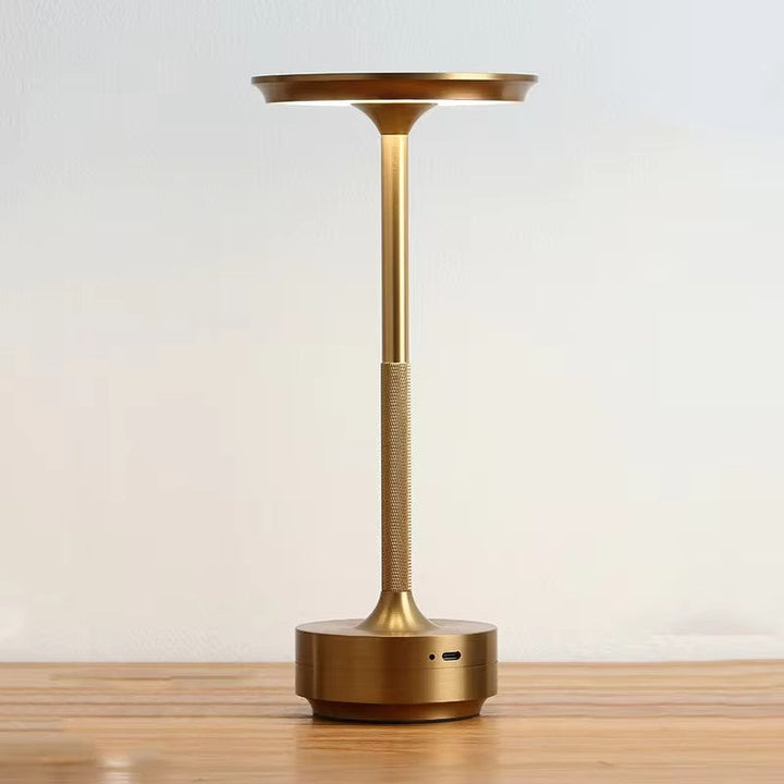 "Sleek cordless LED table lamp with a touch sensor, featuring a minimalist design in available colors: black, gold, silver."