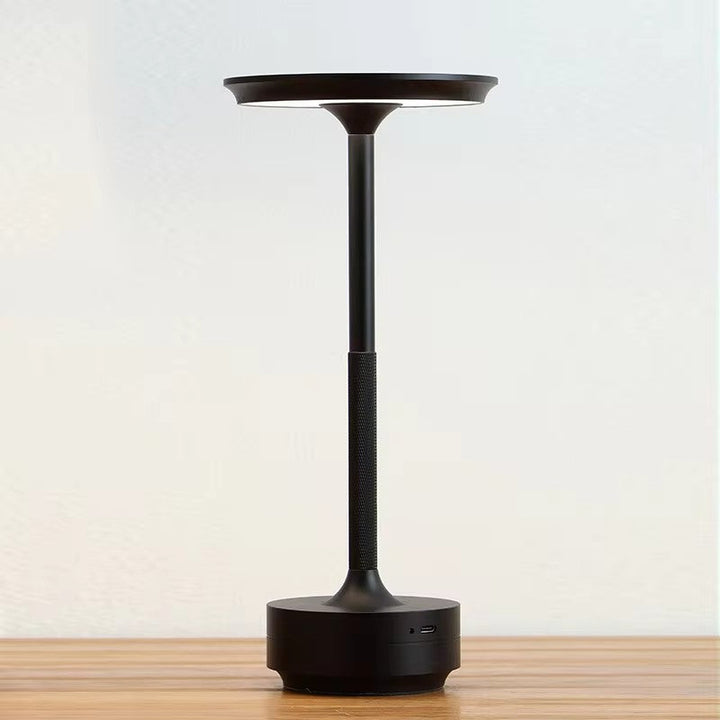 "Sleek cordless LED table lamp with a touch sensor, featuring a minimalist design in available colors: black, gold, silver."