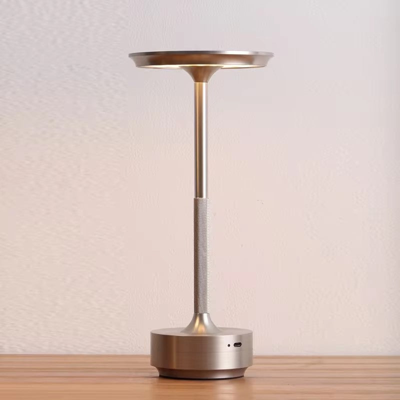 "Sleek cordless LED table lamp with a touch sensor, featuring a minimalist design in available colors: black, gold, silver."