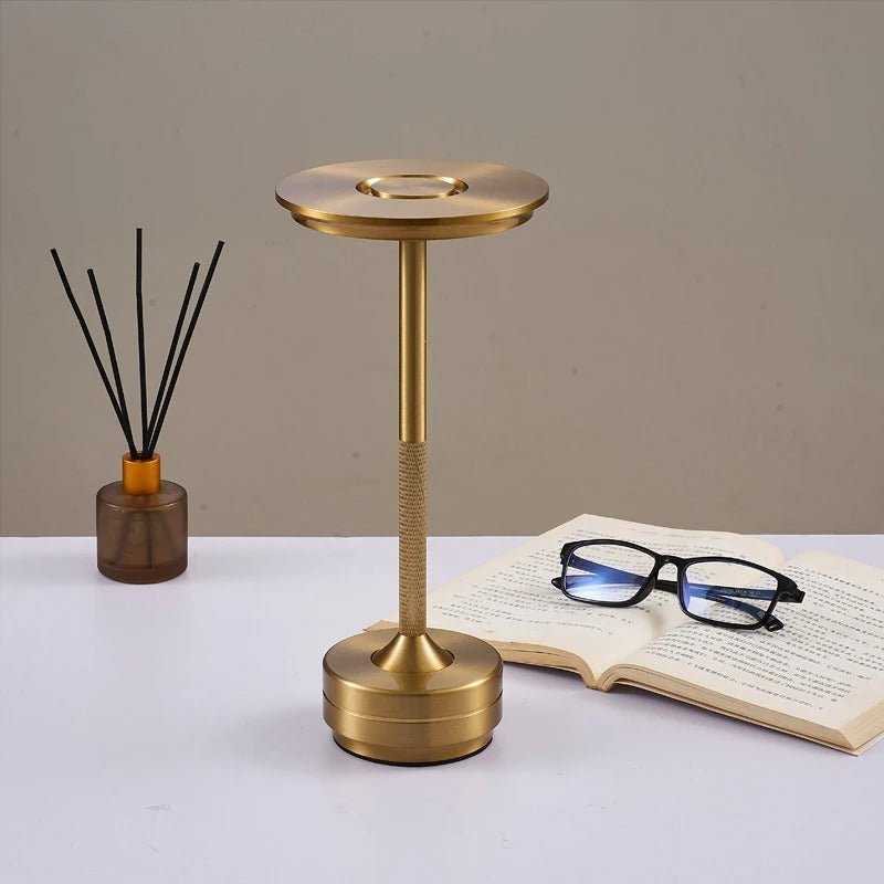 "Sleek cordless LED table lamp with a touch sensor, featuring a minimalist design in available colors: black, gold, silver."
