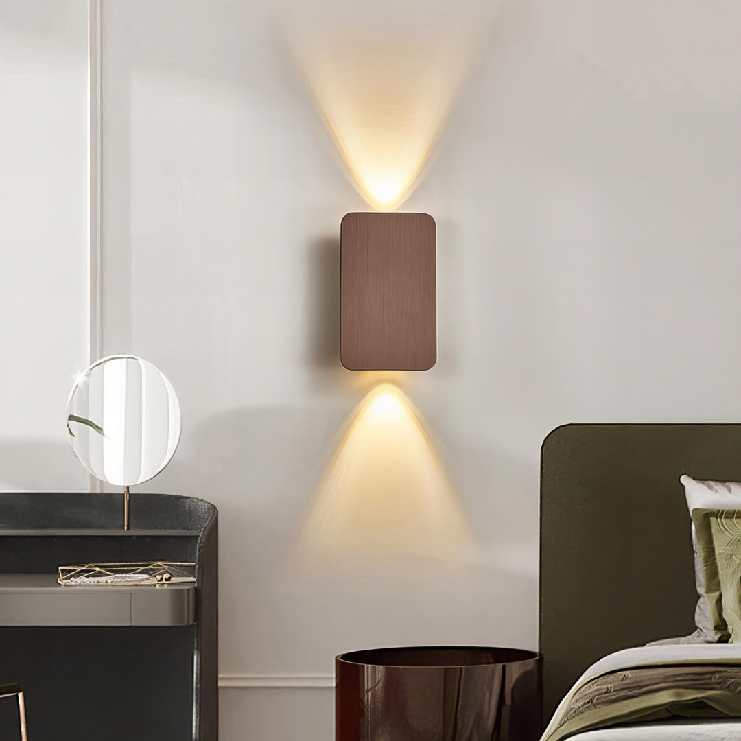 "Sleek indoor LED wall lamp with a modern rectangular design, featuring smooth finishes and warm illumination for elegant dec