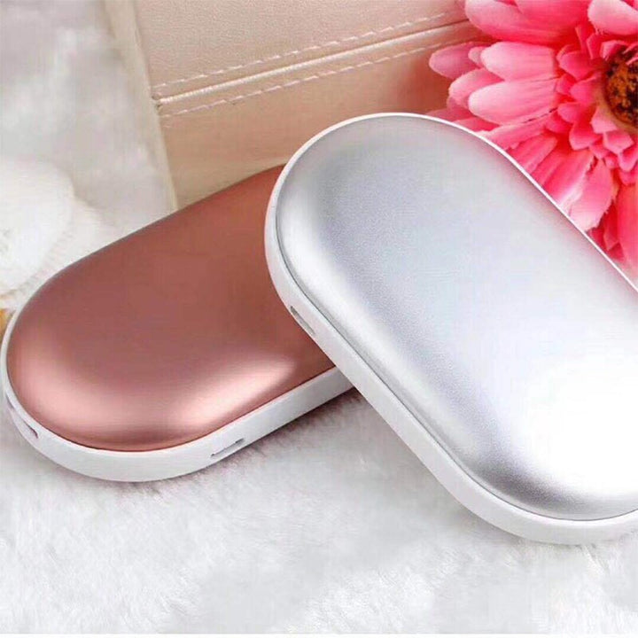 "Sleek silver portable USB hand warmer and powerbank, compact size, double-sided heating, ideal for chilly outdoor use."