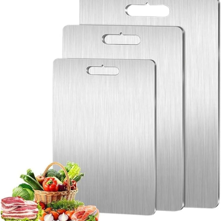 "Sleek stainless steel cutting board in use, showing durability and knife-friendly surface for kitchen prep tasks."