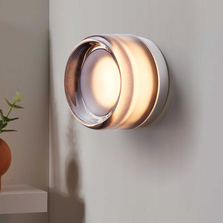 "Sleek wall mounted LED sconce light with acrylic and aluminum design, offering versatile decor enhancement for modern interi