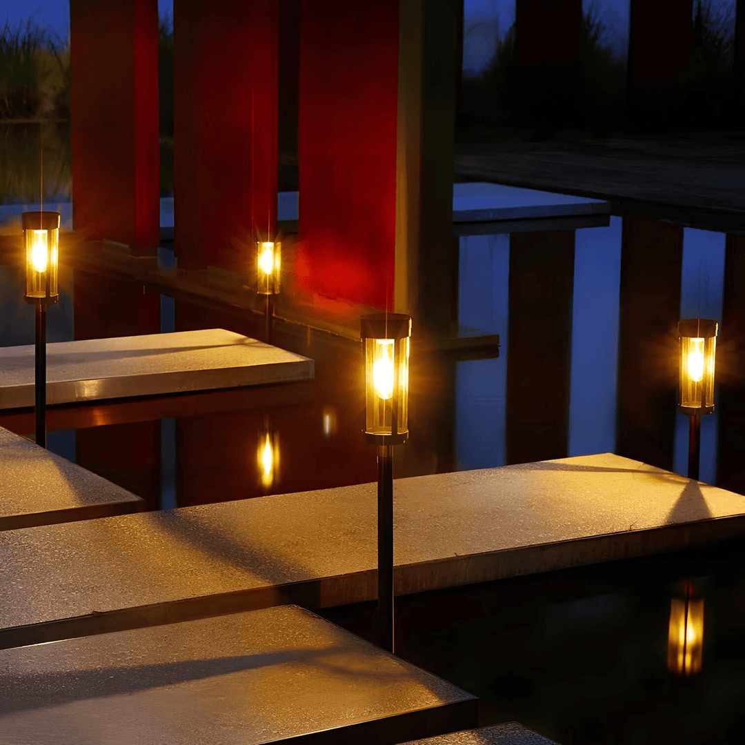 Solar-powered waterproof garden torch with flickering glow, decorative design, illuminating gardens, patios, and pathways.