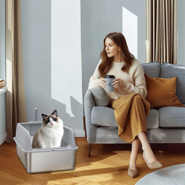 "Stainless steel cat litter box with easy front access and tall sides, ideal for hygienic pet spaces and easy maintenance."