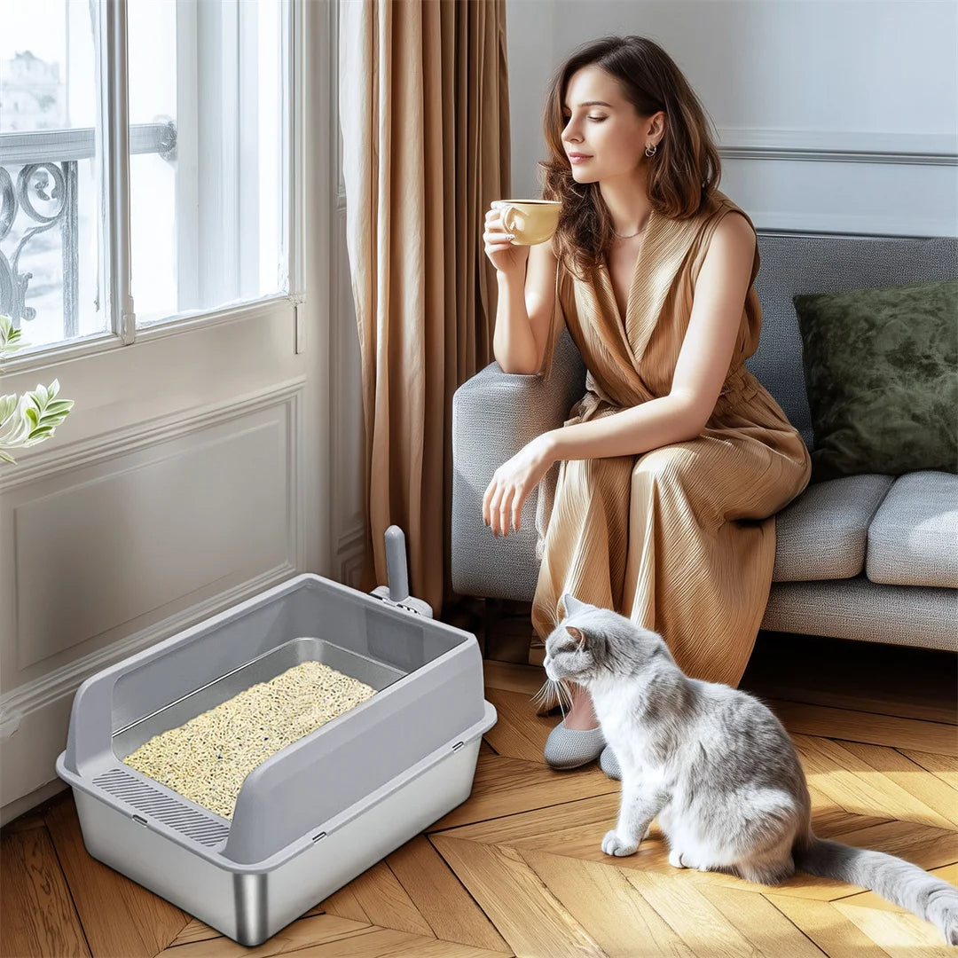 "Stainless steel cat litter box with easy front access and tall sides, ideal for hygienic pet spaces and easy maintenance."