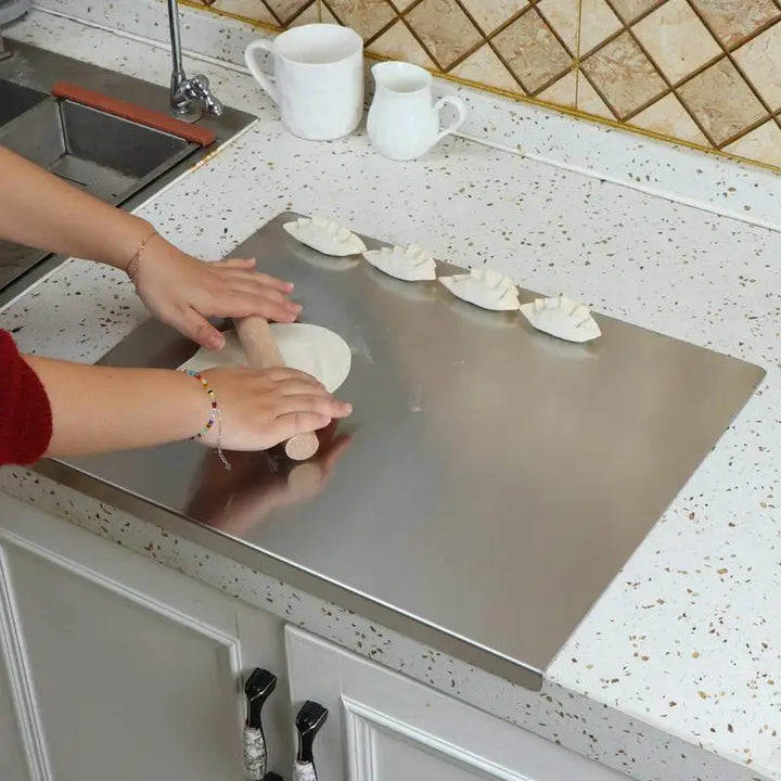 Stainless steel chopping board with non-slip silicone pads, sleek finish, ideal for meat, fish, veggies slicing.