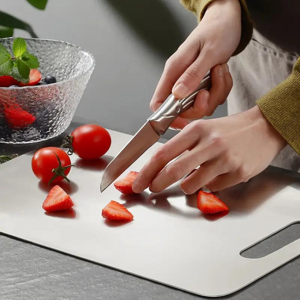 "Stainless steel cutting board, non-slip, scratch-resistant surface for hygienic food prep, sleek design for kitchen use."