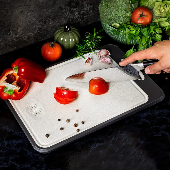 Stainless steel cutting board with a smooth finish and non-slip ergonomic handle, ideal for precise and hygienic kitchen prep